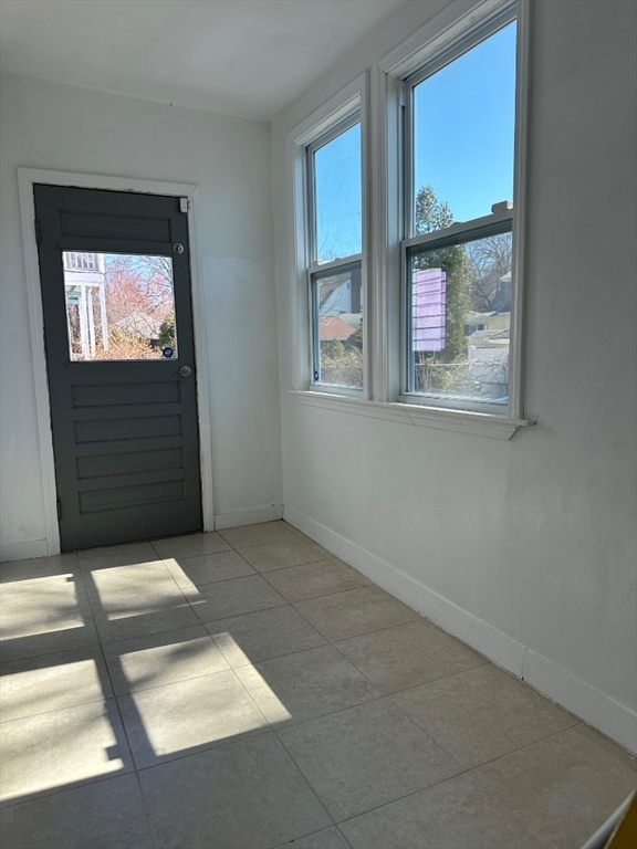 78 Harriet Street, Unit 1 Boston, MA 02135 - Photo 12 of 22 an empty room with windows