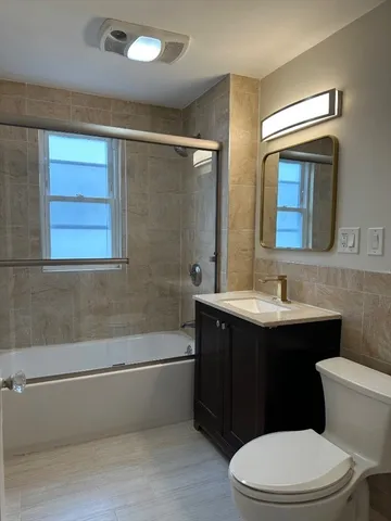 a bathroom with a sink a toilet a mirror and vanity