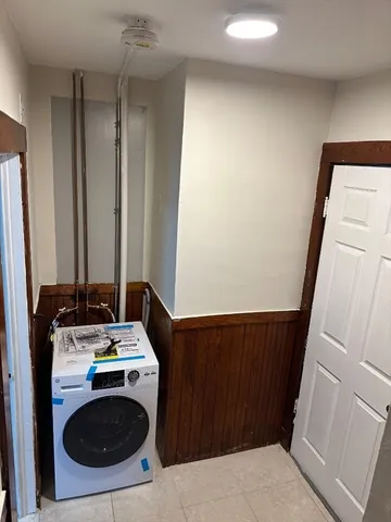a storage room with wooden floor and washing machine
