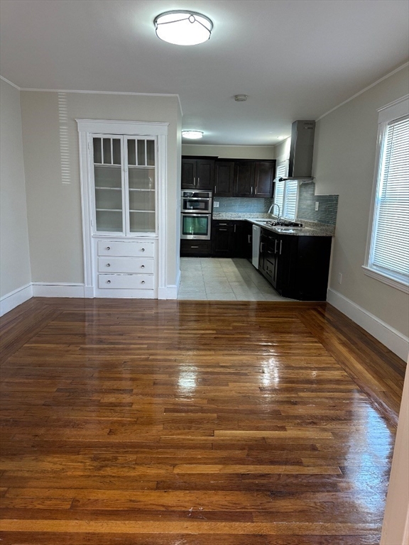78 Harriet Street, Unit 1 Boston, MA 02135 - Photo 16 of 22 a view of kitchen with wooden cabinet and a window
