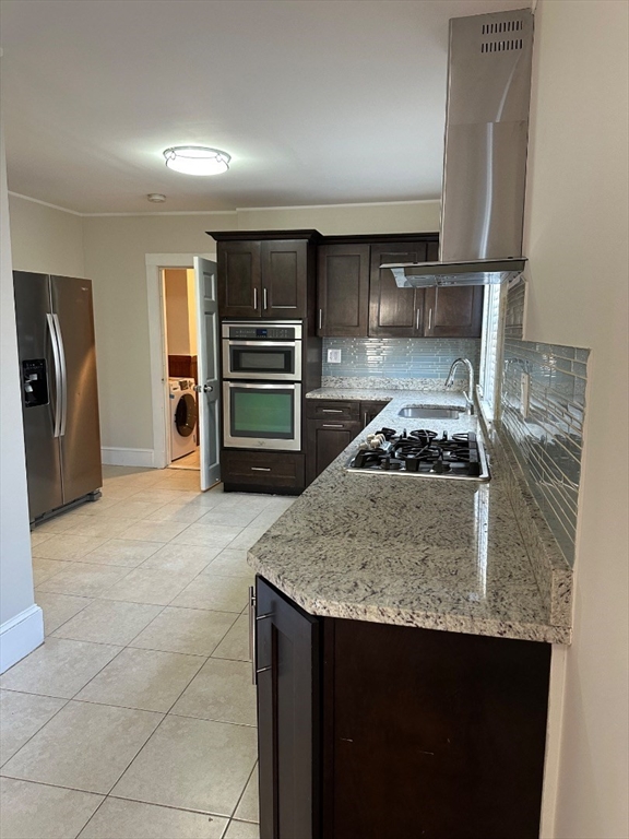 78 Harriet Street, Unit 1 Boston, MA 02135 - Photo 3 of 22 a kitchen with a stove a refrigerator and cabinets