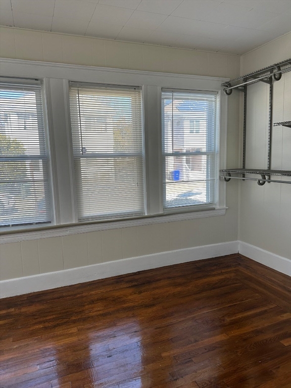 78 Harriet Street, Unit 1 Boston, MA 02135 - Photo 6 of 22 a view of an empty room with wooden floor and a window