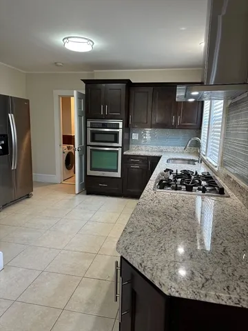 a kitchen with kitchen island a stove and a refrigerator