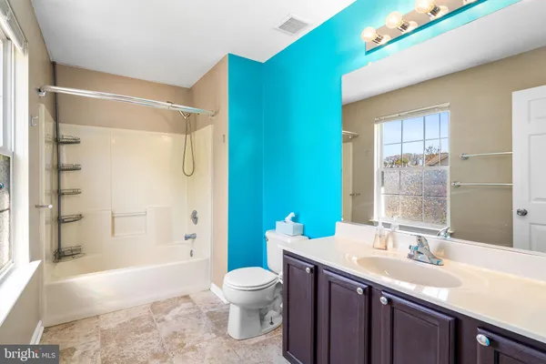 an empty room with a window and a ceiling fan