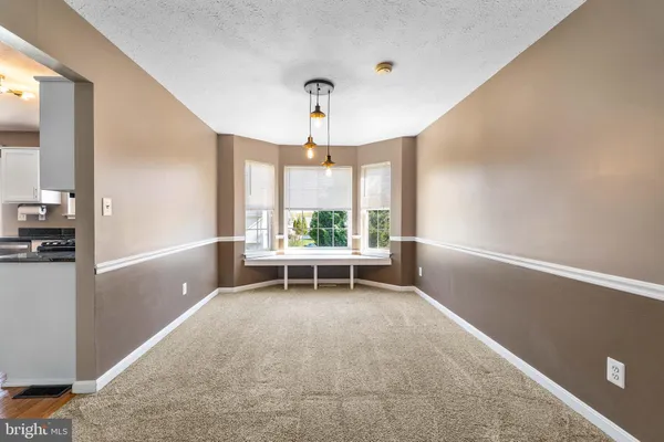 a kitchen with granite countertop a stove top oven a sink and a microwave