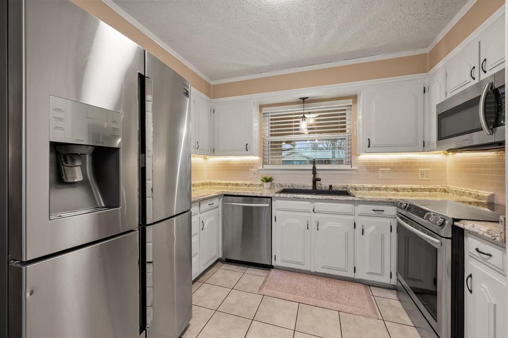 806 Ridgeway Road Joshua, TX 76058 - Photo 11 of 27 a kitchen with stainless steel appliances granite countertop a refrigerator sink and stove
