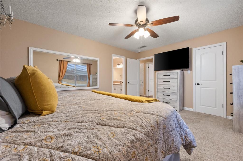 806 Ridgeway Road Joshua, TX 76058 - Photo 17 of 27 a bedroom with a bed and a flat screen tv