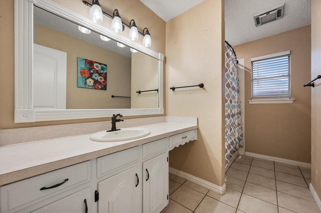 806 Ridgeway Road Joshua, TX 76058 - Photo 21 of 27 a bathroom with a sink and a mirror
