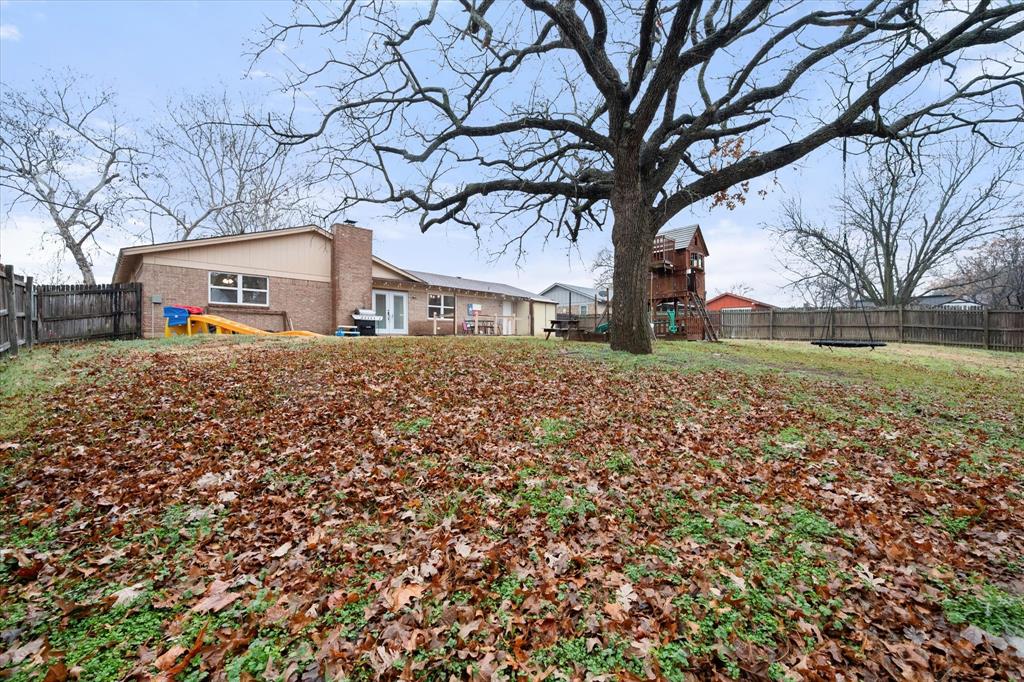806 Ridgeway Road Joshua, TX 76058 - Photo 24 of 27 a house that has a tree in front of it