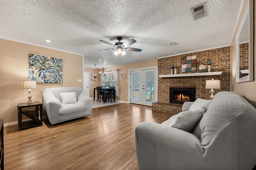 806 Ridgeway Road Joshua, TX 76058 - Photo 7 of 27 a living room with furniture a fireplace and a flat screen tv