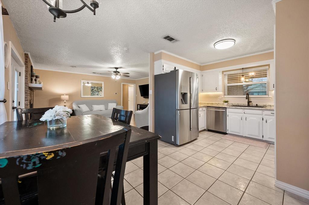806 Ridgeway Road Joshua, TX 76058 - Photo 10 of 27 a kitchen with stainless steel appliances kitchen island granite countertop a sink refrigerator and cabinets