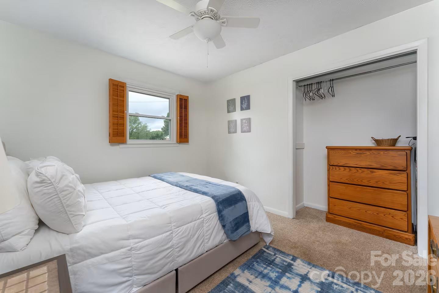 124 Oak Hill Road Candler, NC 28715 - Photo 15 of 29 a bedroom with a bed and a window