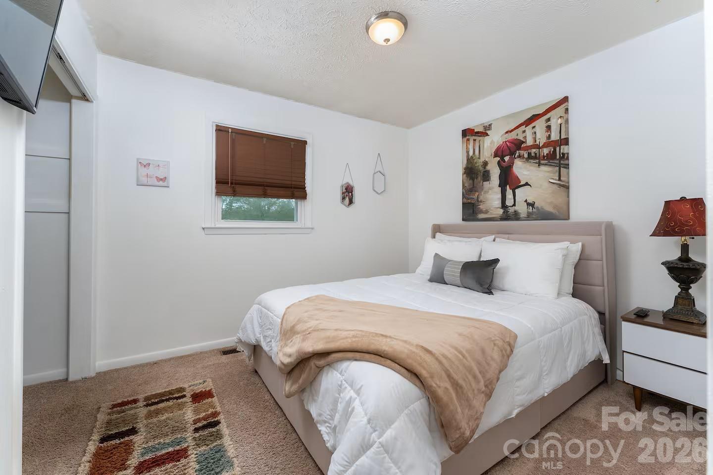 124 Oak Hill Road Candler, NC 28715 - Photo 16 of 29 a bedroom with bed and wooden floor