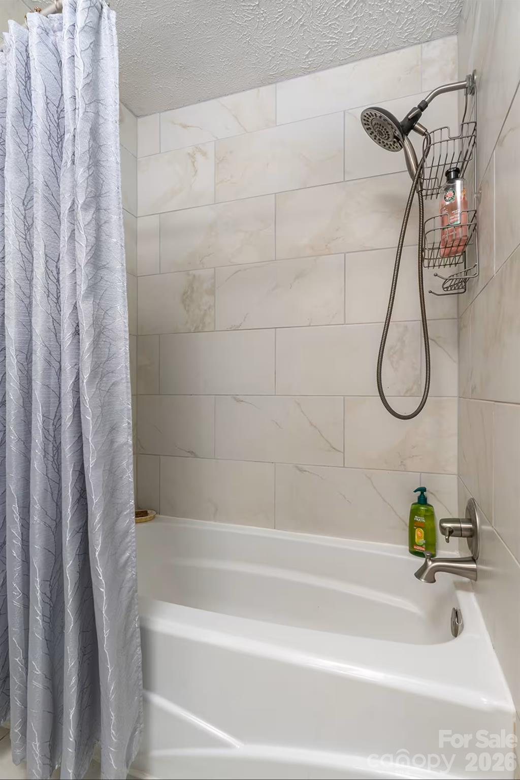 124 Oak Hill Road Candler, NC 28715 - Photo 18 of 29 a bathroom with a bath tub with a shower