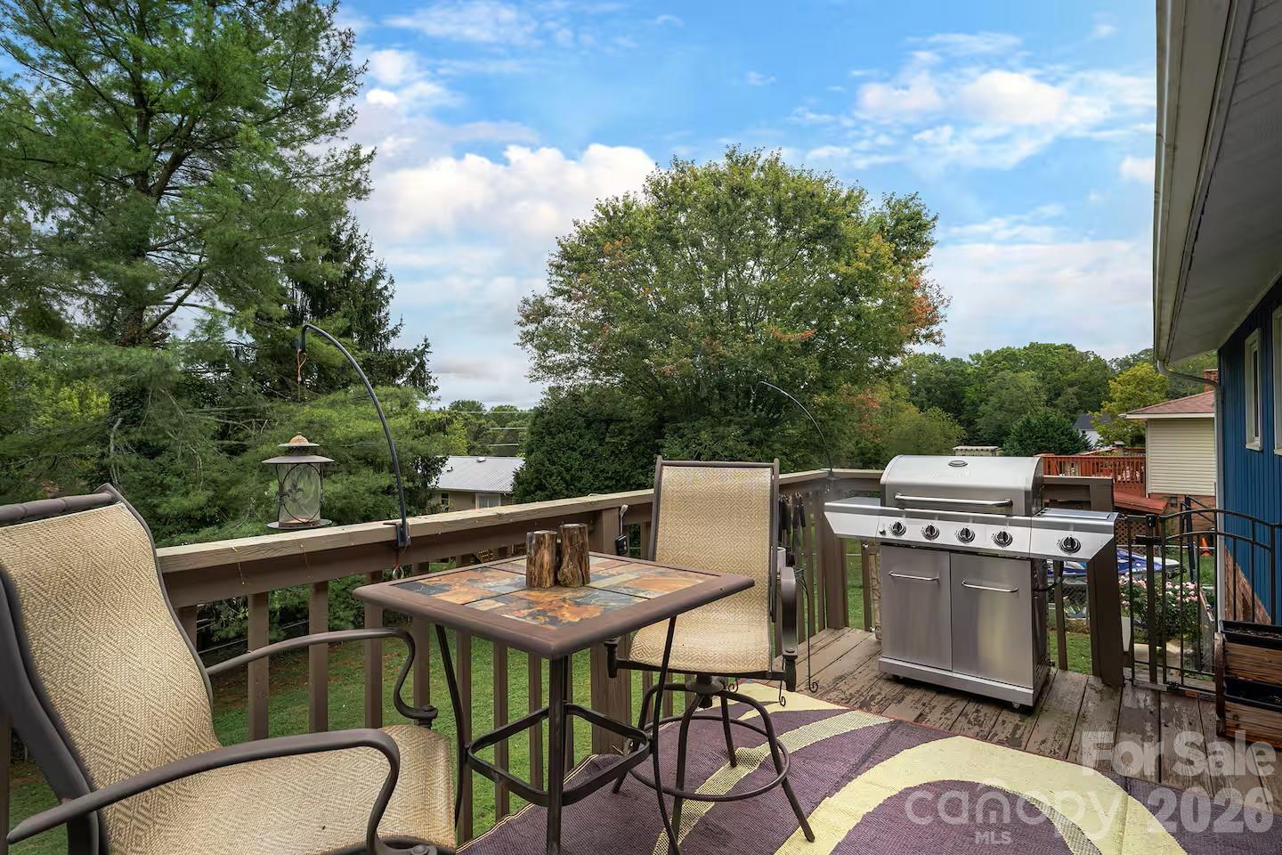 124 Oak Hill Road Candler, NC 28715 - Photo 19 of 29 a balcony with table and chairs