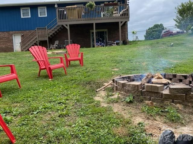 124 Oak Hill Road Candler, NC 28715 - Photo 24 of 29 a backyard of a house with table and chairs