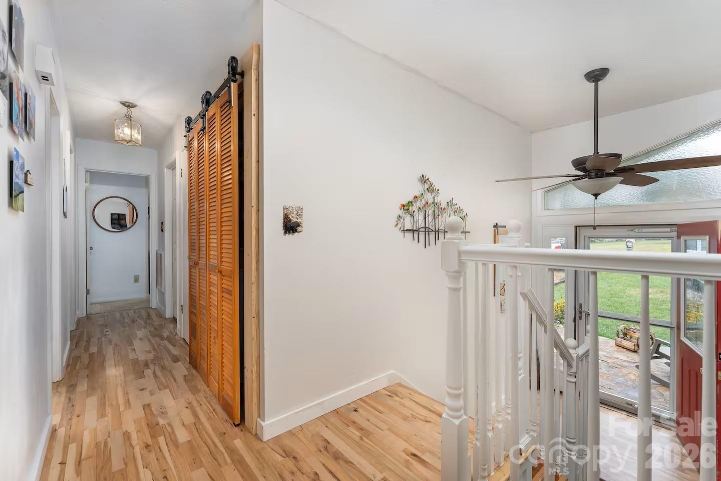 124 Oak Hill Road Candler, NC 28715 - Photo 4 of 29 a view of a hallway with wooden floor and staircase
