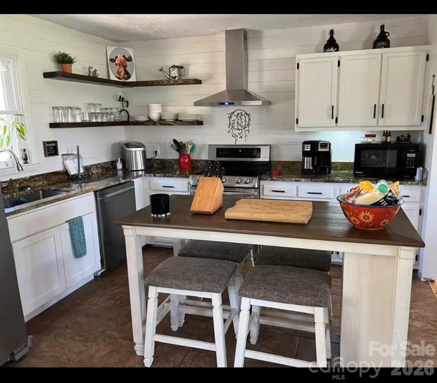 124 Oak Hill Road Candler, NC 28715 - Photo 5 of 29 a kitchen with stainless steel appliances granite countertop a stove and a white cabinets