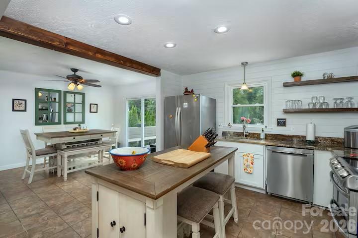 124 Oak Hill Road Candler, NC 28715 - Photo 7 of 29 a kitchen with stainless steel appliances granite countertop a stove a sink dishwasher and cabinets with wooden floor
