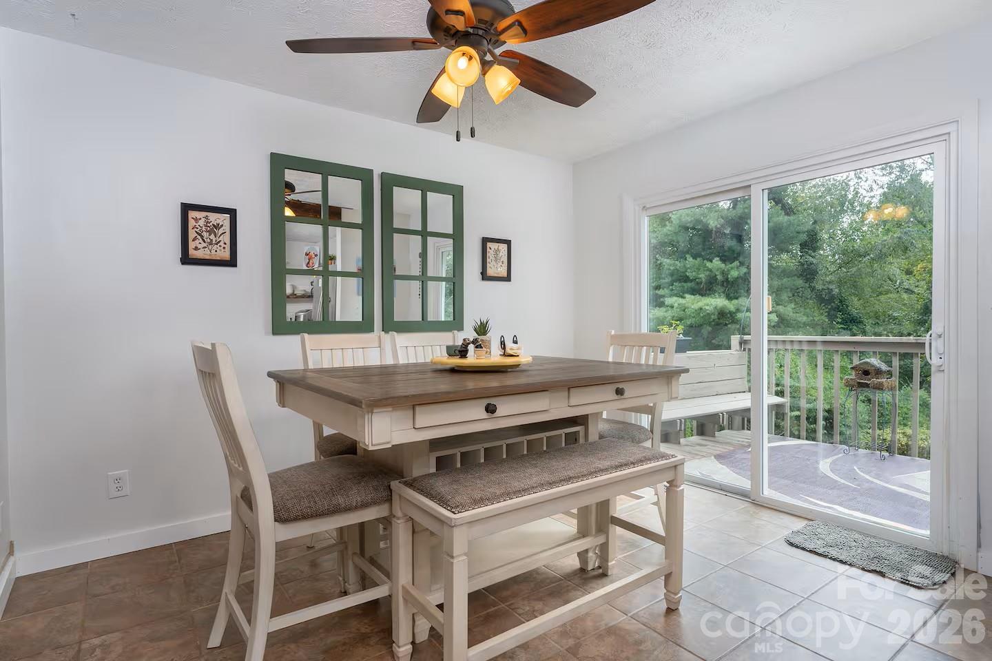124 Oak Hill Road Candler, NC 28715 - Photo 9 of 29 a dining room with wooden floor and a floor to ceiling window