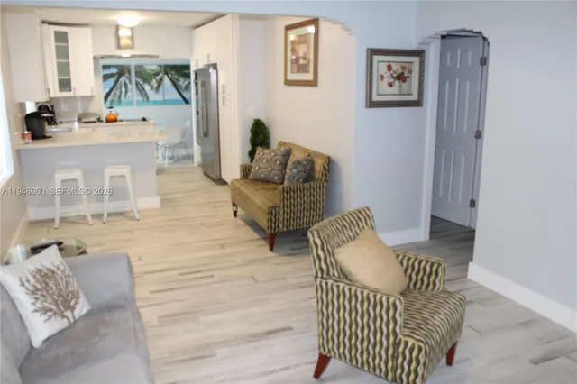 a balcony with furniture and painting on the wall