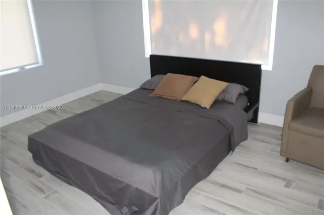 a bed sitting in a bedroom next to a window