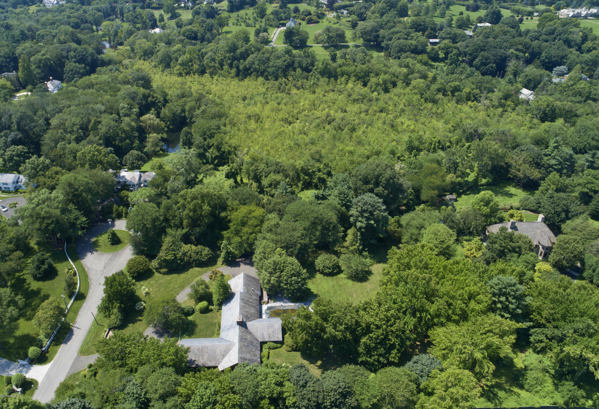 an aerial view of a house with yard