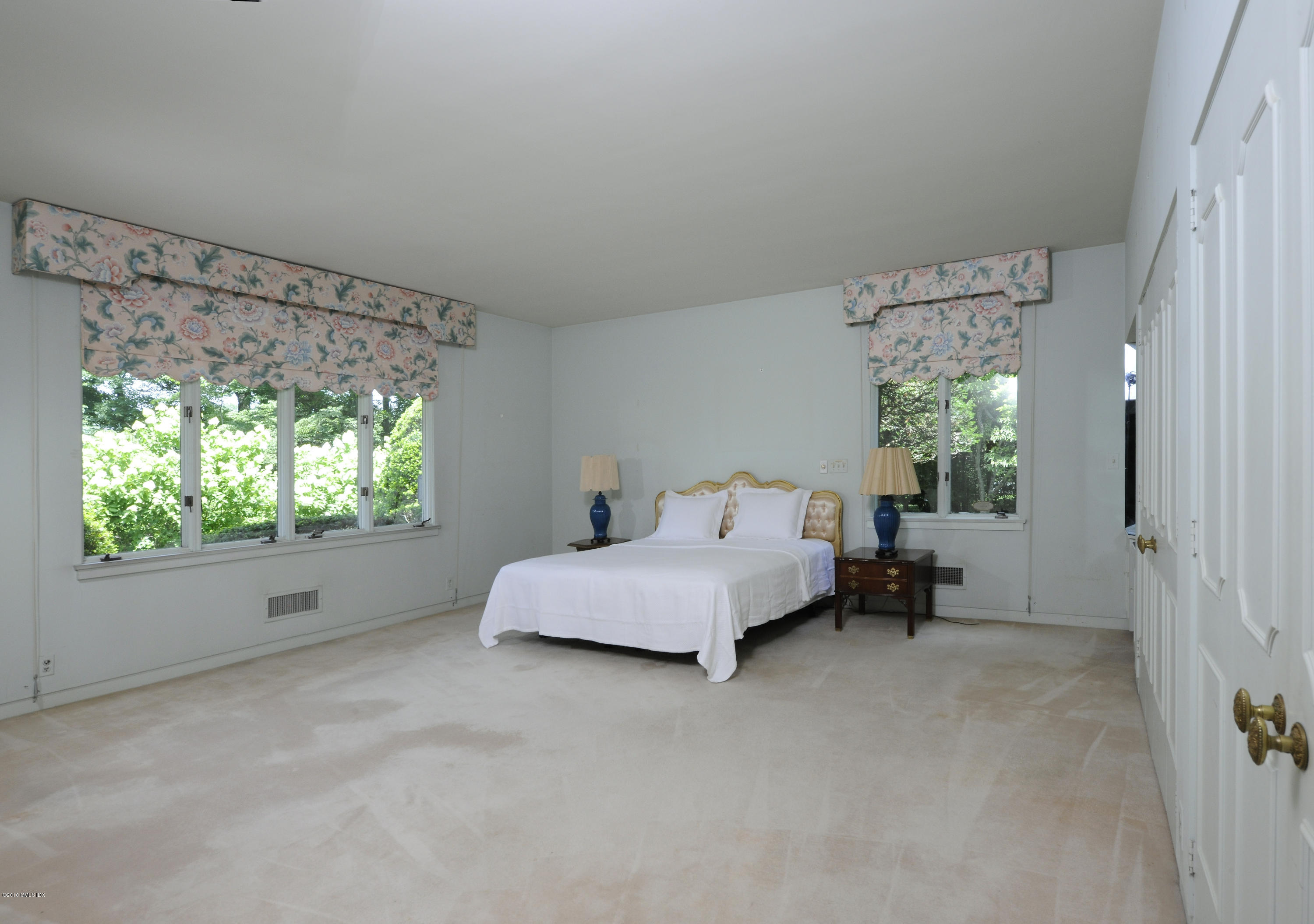 7 Dempsey Lane Greenwich, CT 06830 - Photo 13 of 22 a spacious bedroom with a bed and a window