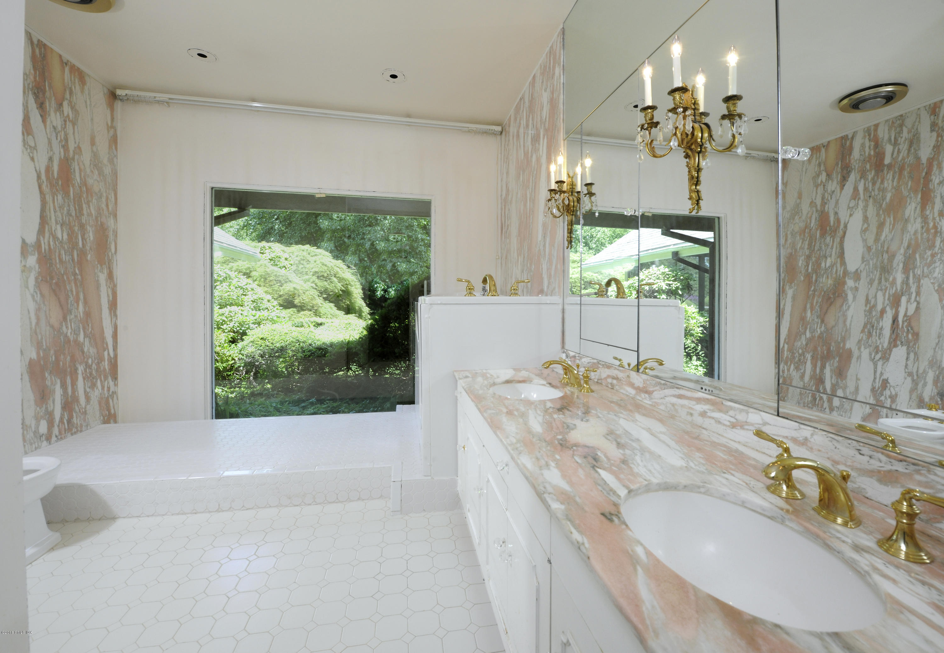 7 Dempsey Lane Greenwich, CT 06830 - Photo 14 of 22 a bathroom with a granite countertop tub a sink and a large mirror