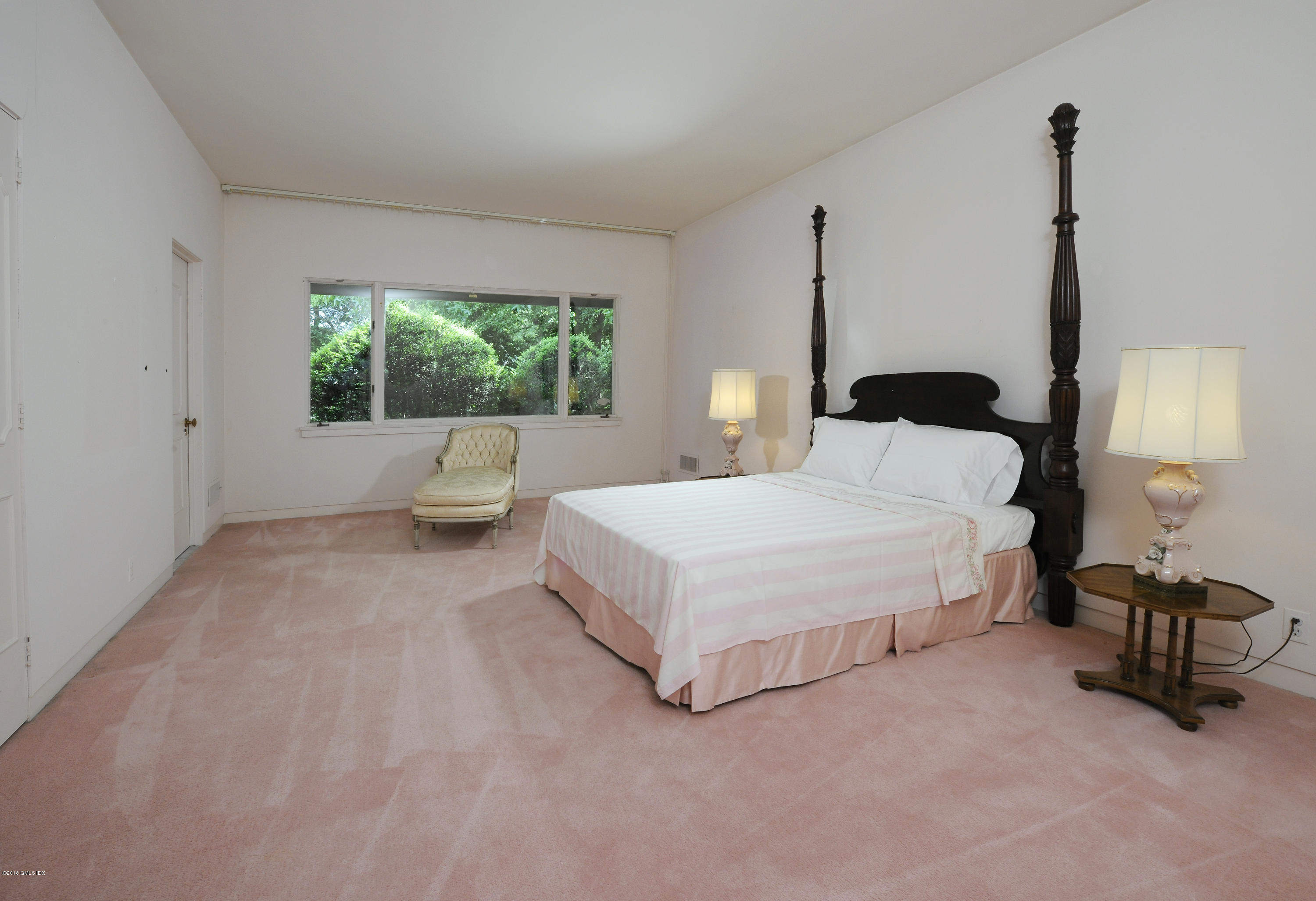 7 Dempsey Lane Greenwich, CT 06830 - Photo 15 of 22 a bedroom with a bed and a window