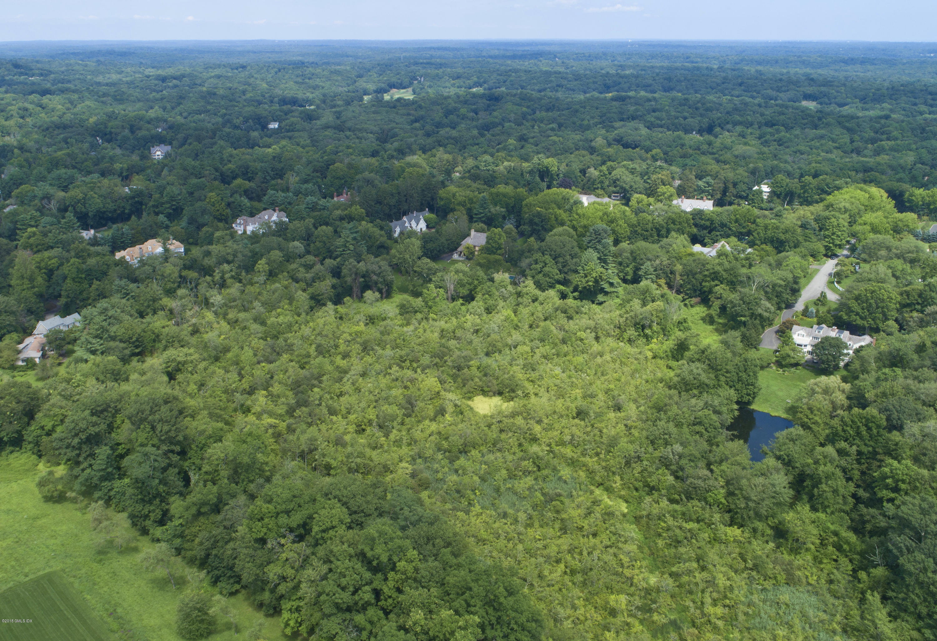 7 Dempsey Lane Greenwich, CT 06830 - Photo 19 of 22 a view of a green field with lots of trees