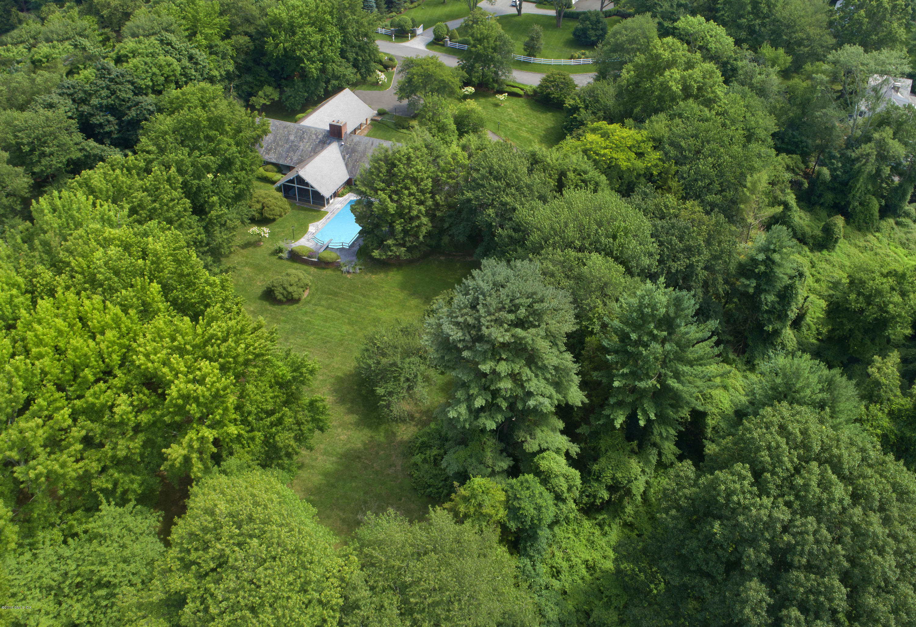 7 Dempsey Lane Greenwich, CT 06830 - Photo 3 of 22 a backyard of a house with lots of green space and trees