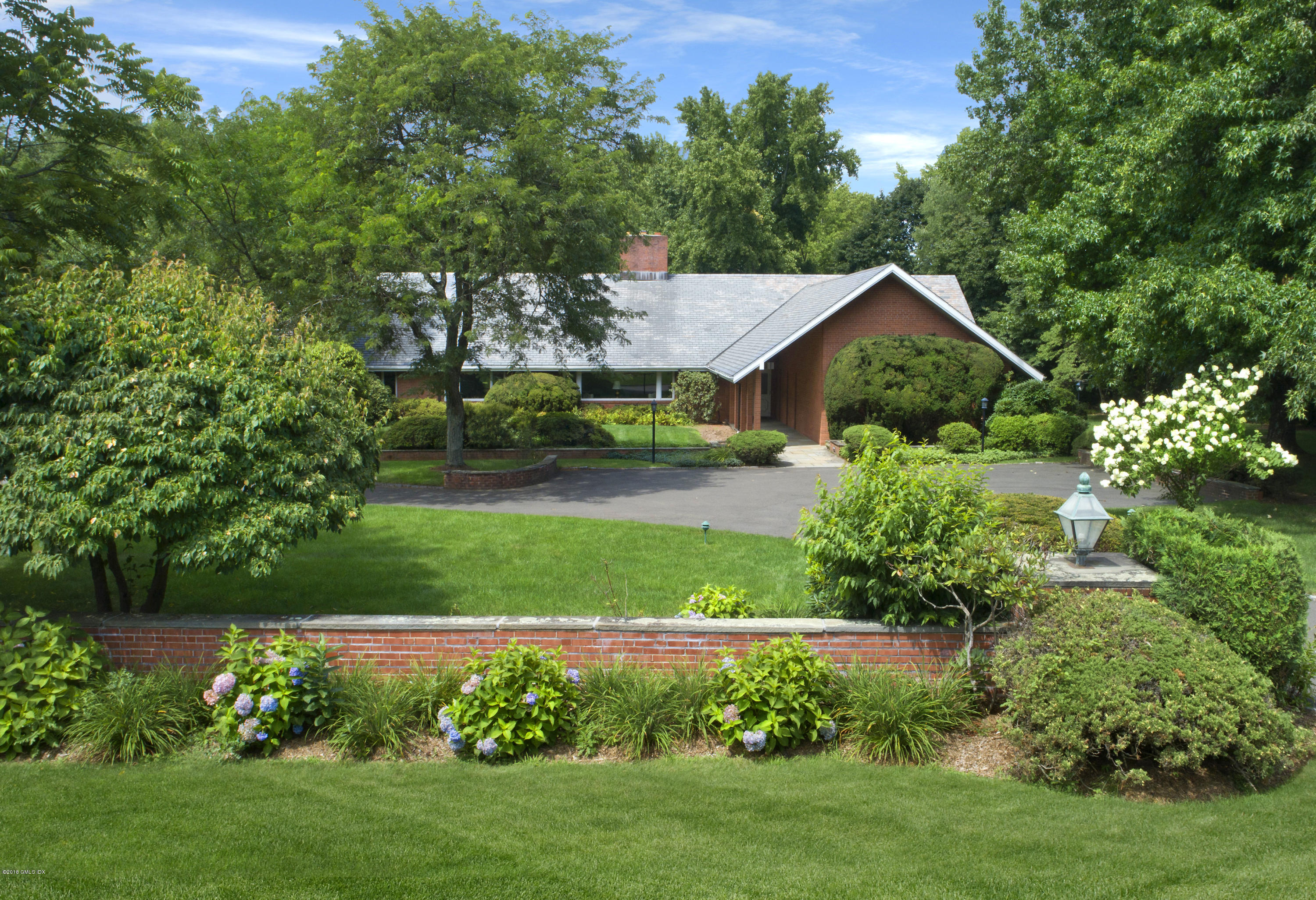 7 Dempsey Lane Greenwich, CT 06830 - Photo 5 of 22 a view of a house with a big yard plants and large trees