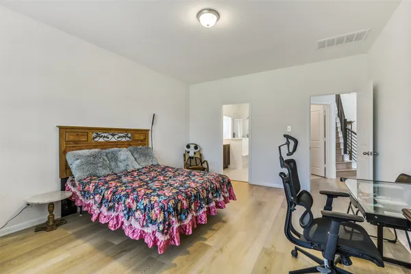 a bedroom with a bed a desk and chair