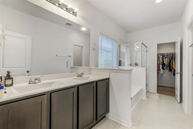 a bathroom with a sink double vanity and a mirror