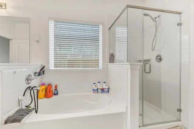 a bathroom with a tub and a shower