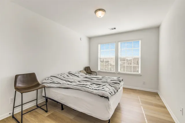 a bedroom with a bed and a chair