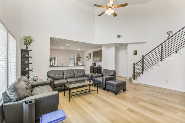 a living room with furniture and a wooden floor