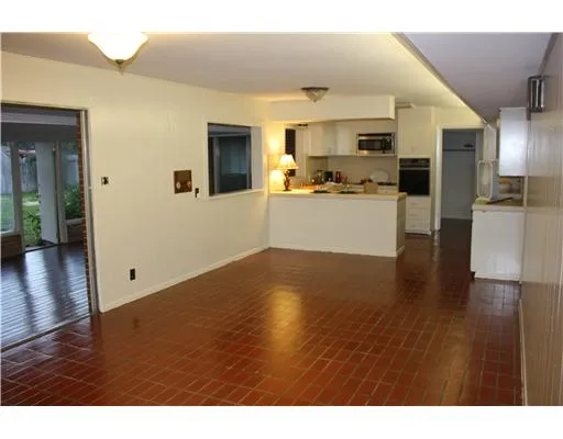 a view of large kitchen with wooden floor