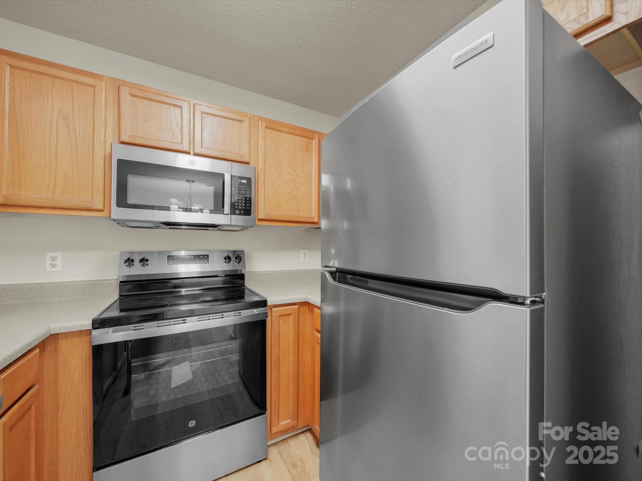 6420 Sunman Road Charlotte, NC 28216 - Photo 12 of 43 a kitchen with a refrigerator stove and microwave