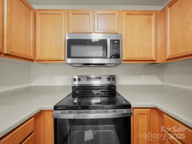 a kitchen with a sink and chandelier