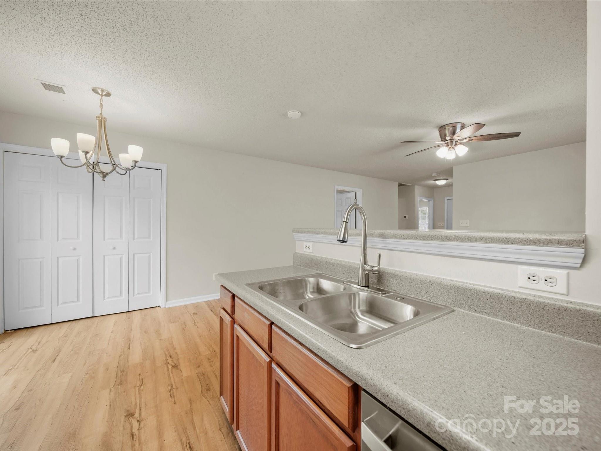6420 Sunman Road Charlotte, NC 28216 - Photo 14 of 43 a kitchen with a sink and chandelier