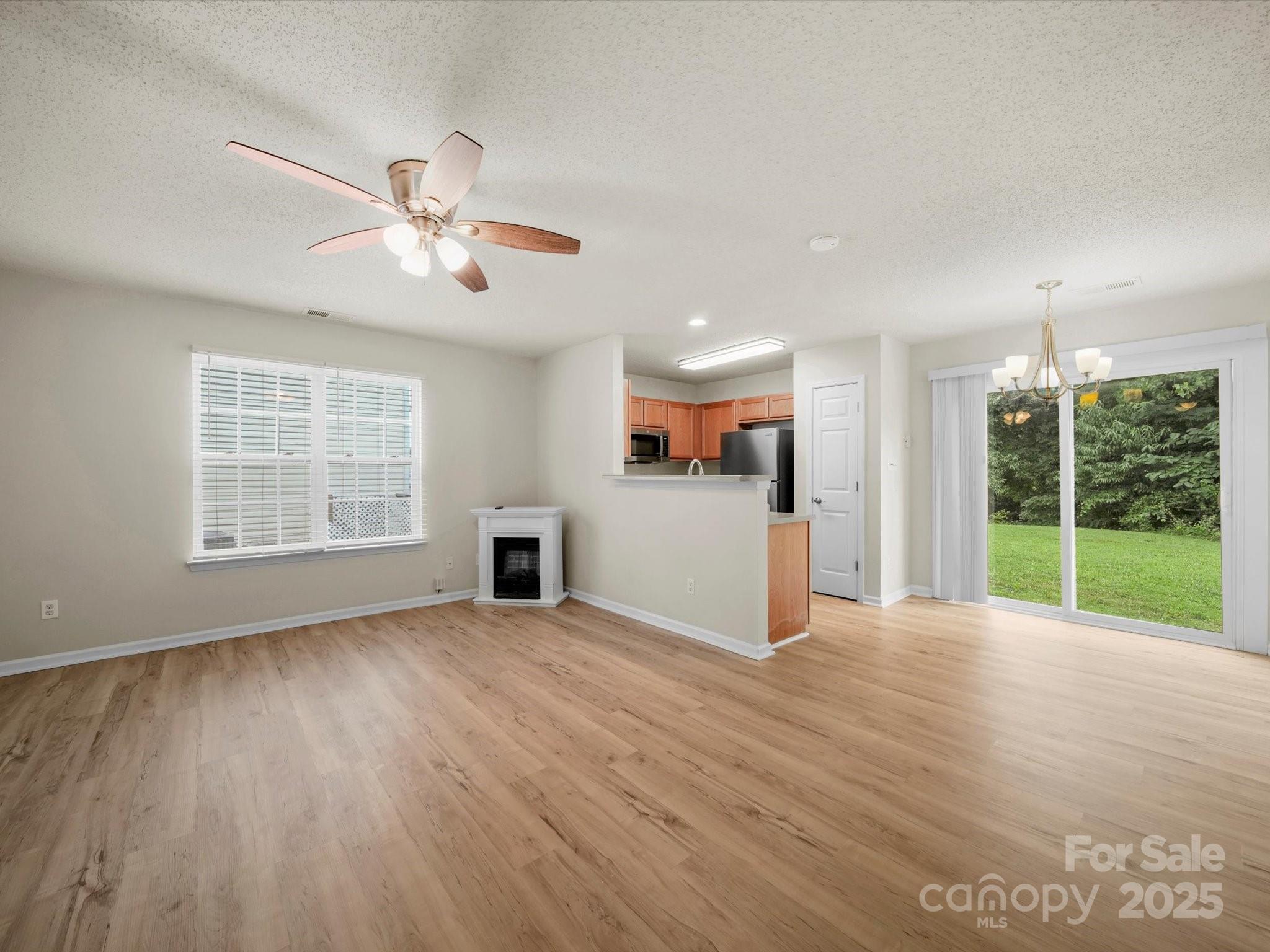 6420 Sunman Road Charlotte, NC 28216 - Photo 22 of 43 a view of an empty room with a window and wooden floor