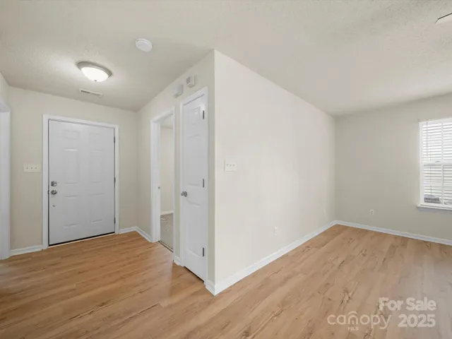 a kitchen with stainless steel appliances granite countertop a refrigerator a sink a stove a microwave and island with wooden floor