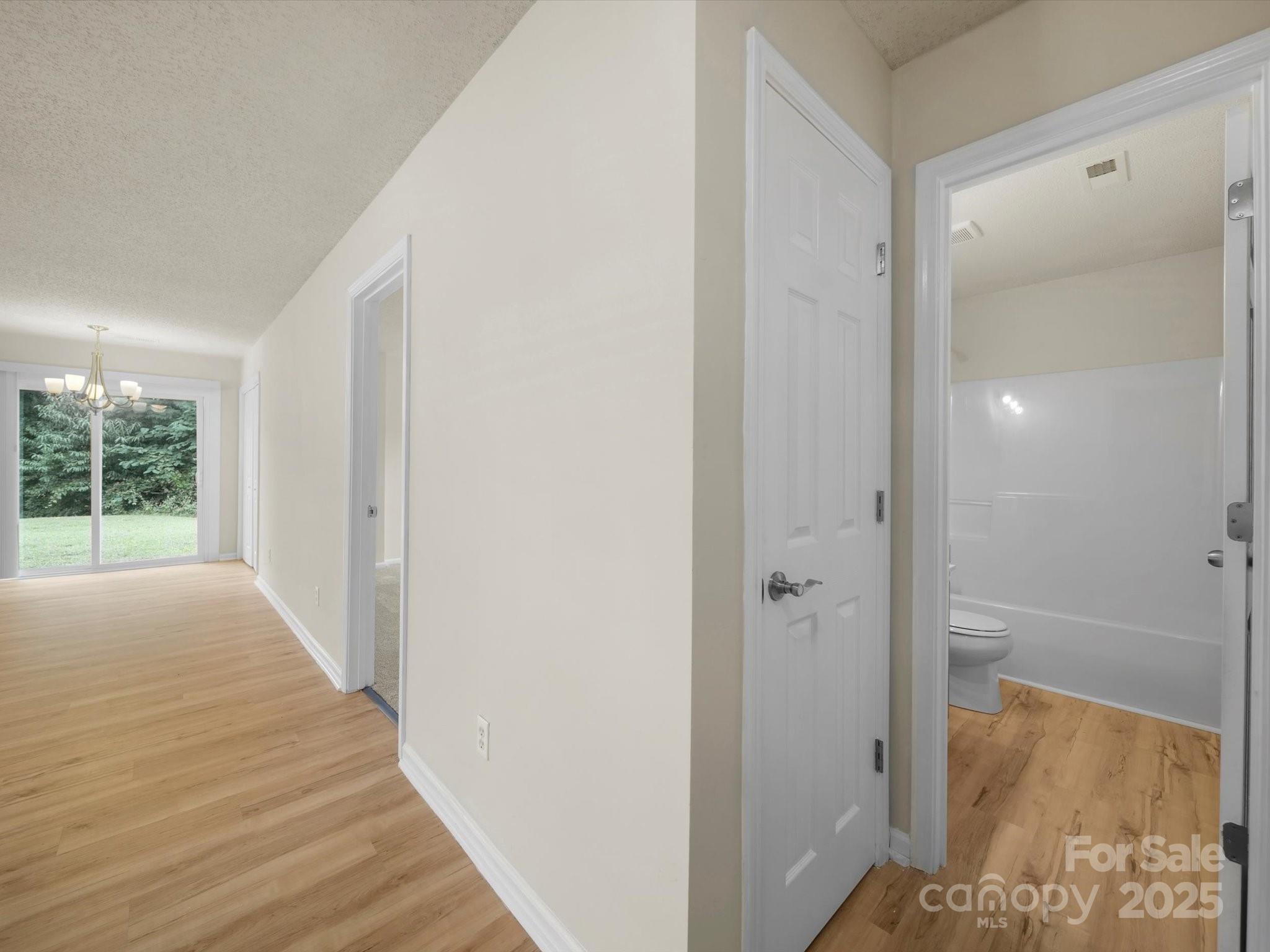 6420 Sunman Road Charlotte, NC 28216 - Photo 37 of 43 a view of a hallway with wooden floor and front door