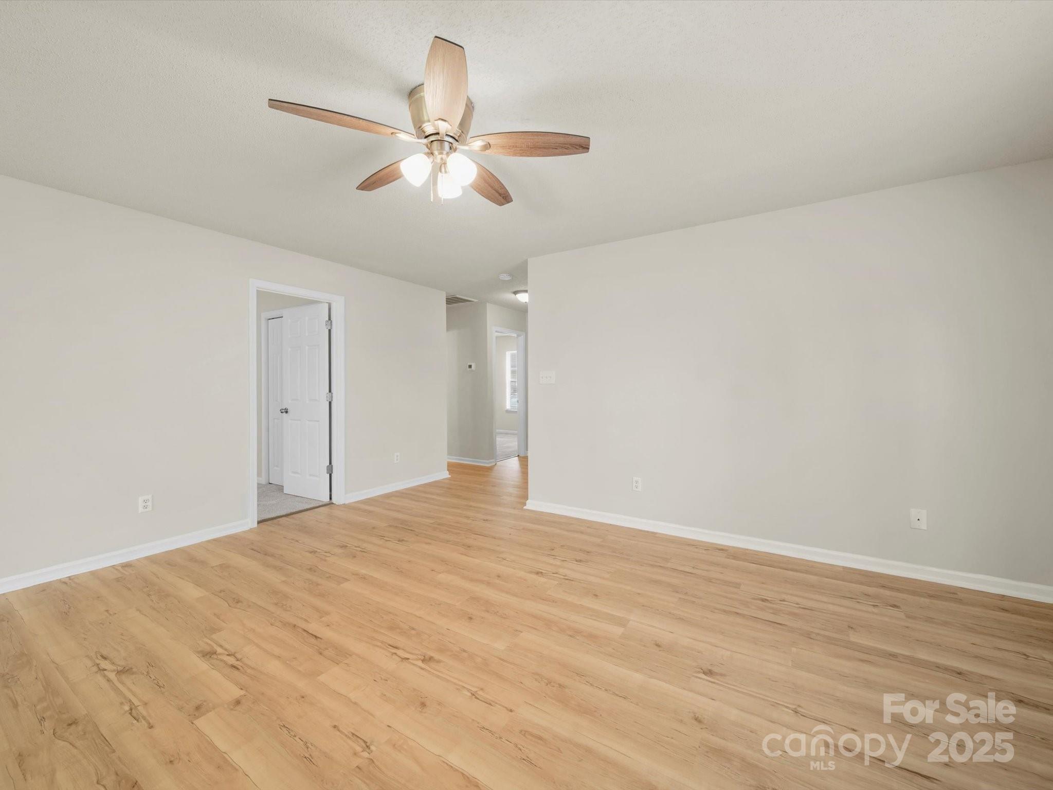 6420 Sunman Road Charlotte, NC 28216 - Photo 6 of 43 a view of an empty room and chandelier fan