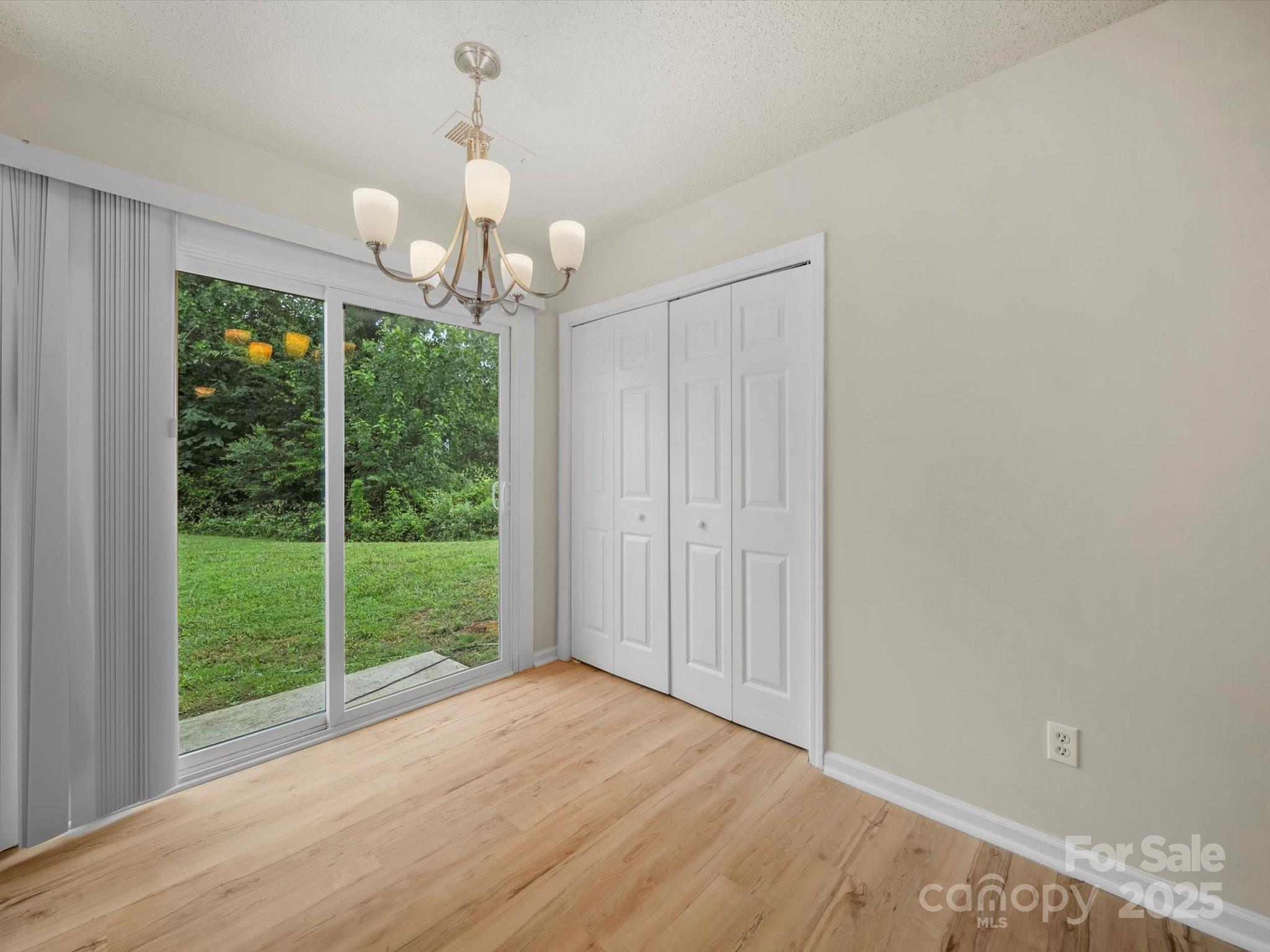 6420 Sunman Road Charlotte, NC 28216 - Photo 9 of 43 a view of a room with wooden floor and outdoor view