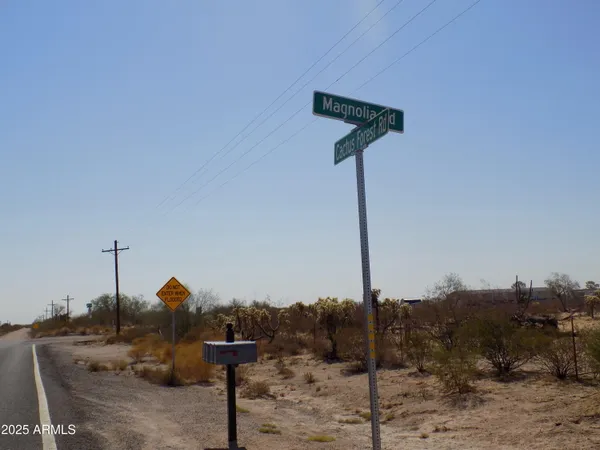 a street sign on a sidewalk next to a road
