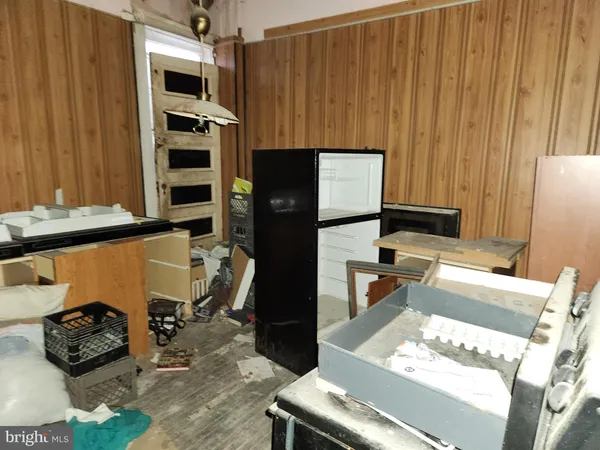a kitchen with stainless steel appliances kitchen island granite countertop a refrigerator oven a sink and dishwasher