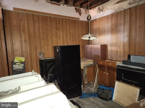 a room with a chair and potted plant